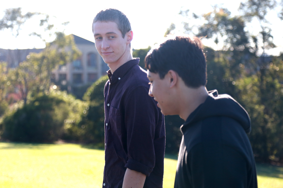 Two teenagers walking and talking to each other