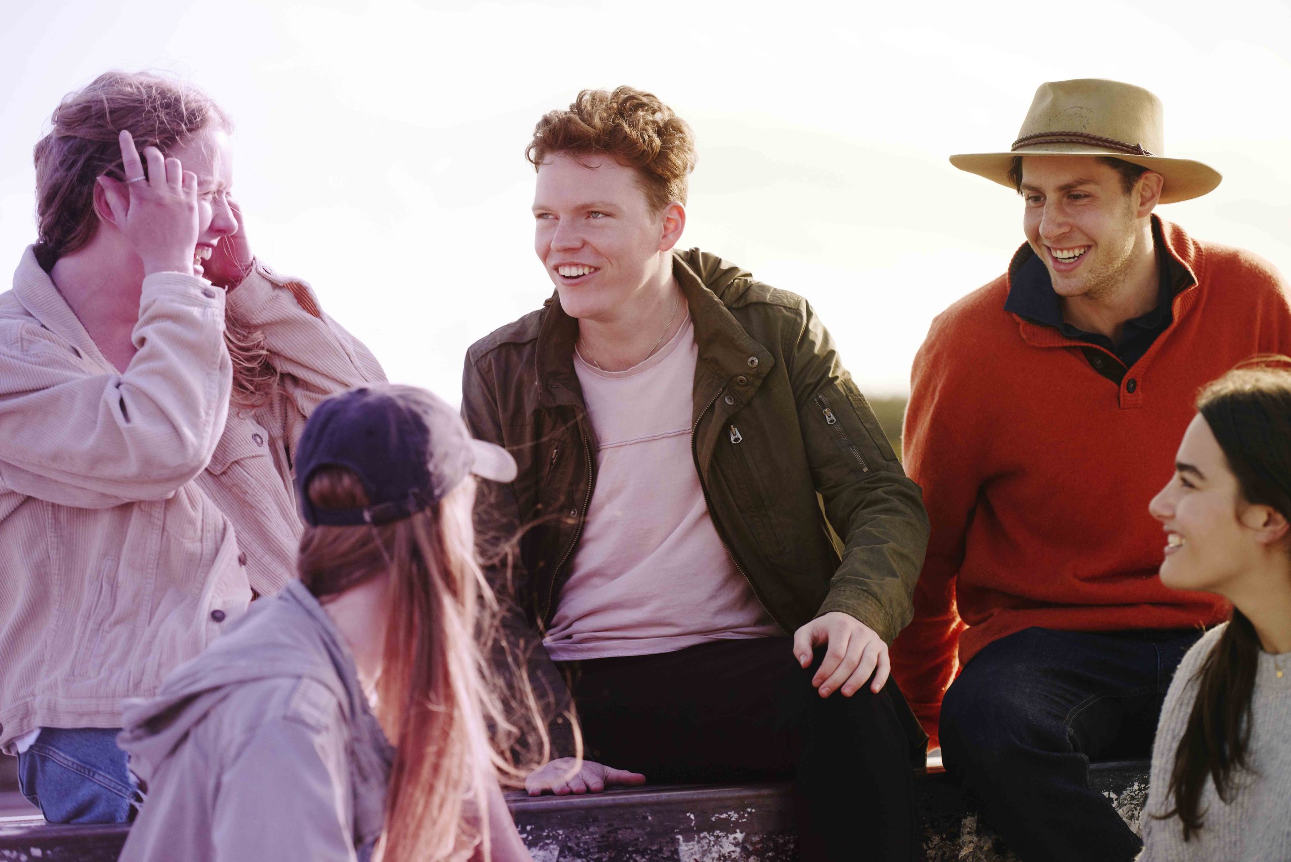 A group of teenagers chatting and smiling Two teenagers walking and talking to each other